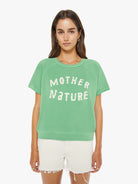 Woman wearing a green 'Mother Nature' t-shirt on a white background