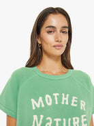 Woman wearing a green 'Mother Nature' t-shirt against a white background