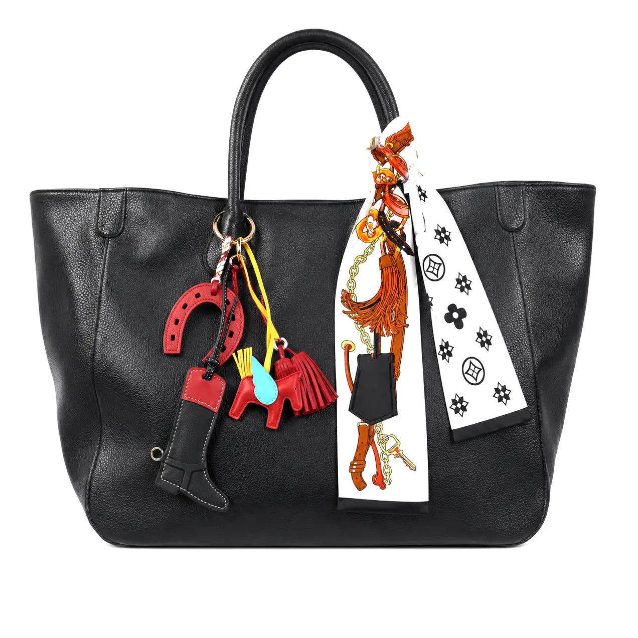 Black handbag with colorful keychain and scarf on a white background