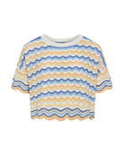 Short-sleeve top with blue and yellow wave pattern on a white background
