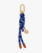Blue rope keychain with gold carabiner and tag on a white background