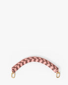Patterned strap with gold hardware on a white background