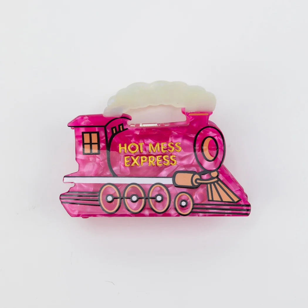A pink marbled hair claw clip shaped like a steam locomotive train, featuring the text 'HOT MESS EXPRESS' in yellow on the side, set against a plain white background.