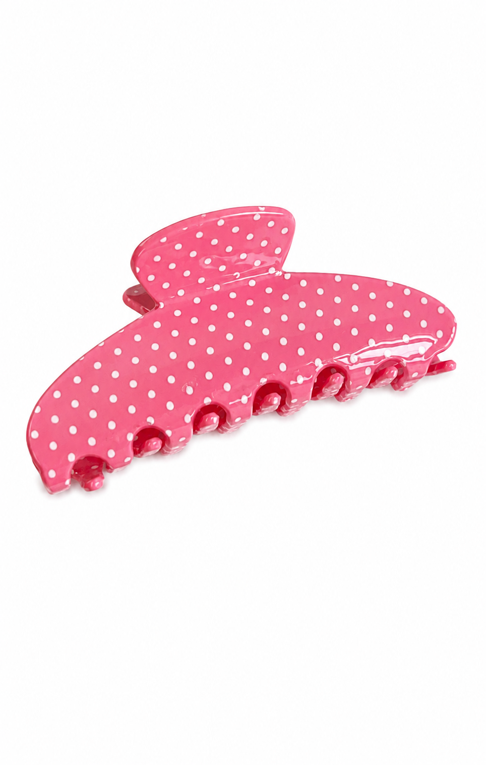 A pink hair claw clip with a white polka dot pattern, shown on a plain white background.