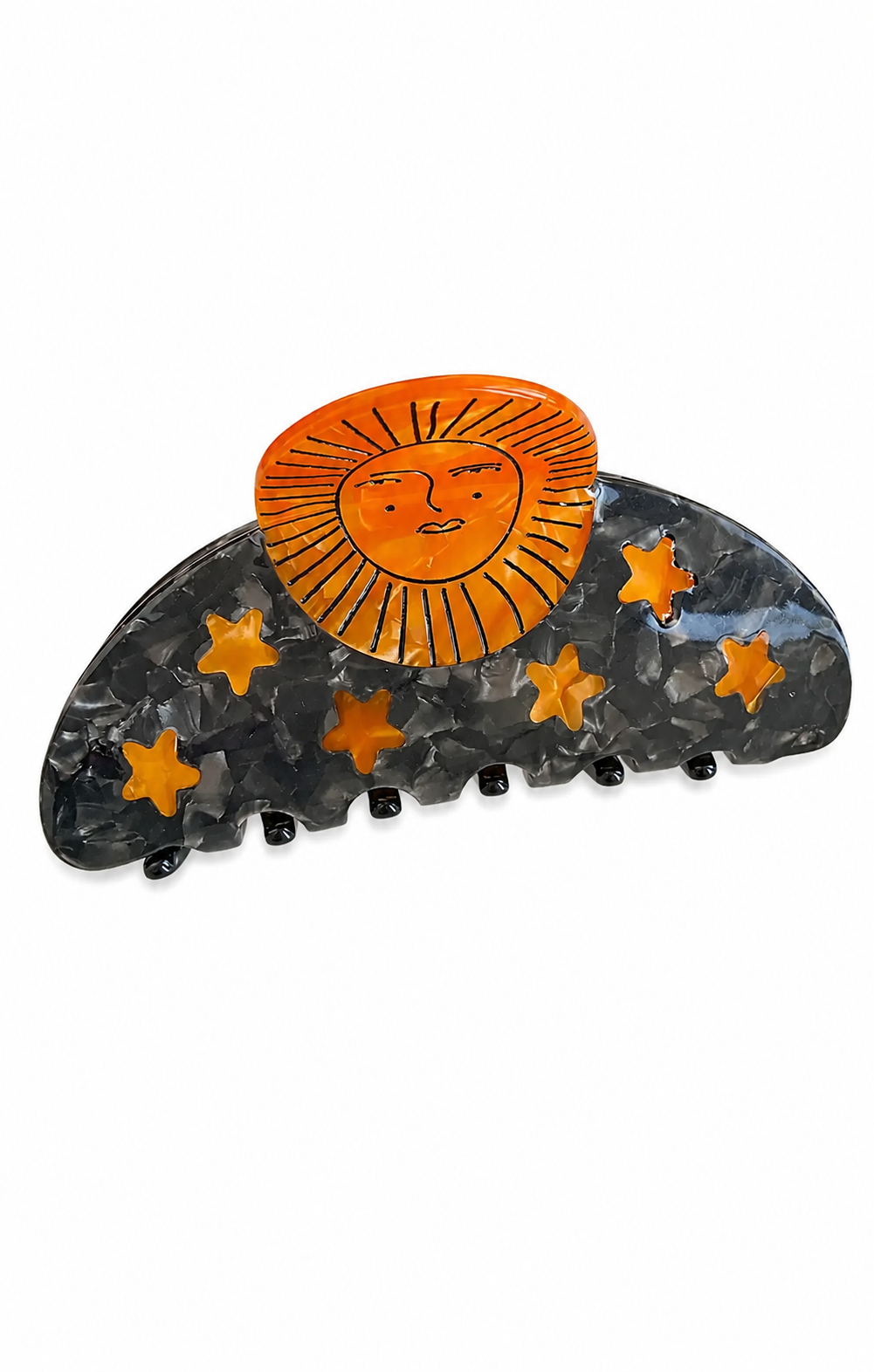 A semi-circular hair claw clip featuring a glossy dark gray marbled base decorated with orange stars, topped with a bright orange sun face design.