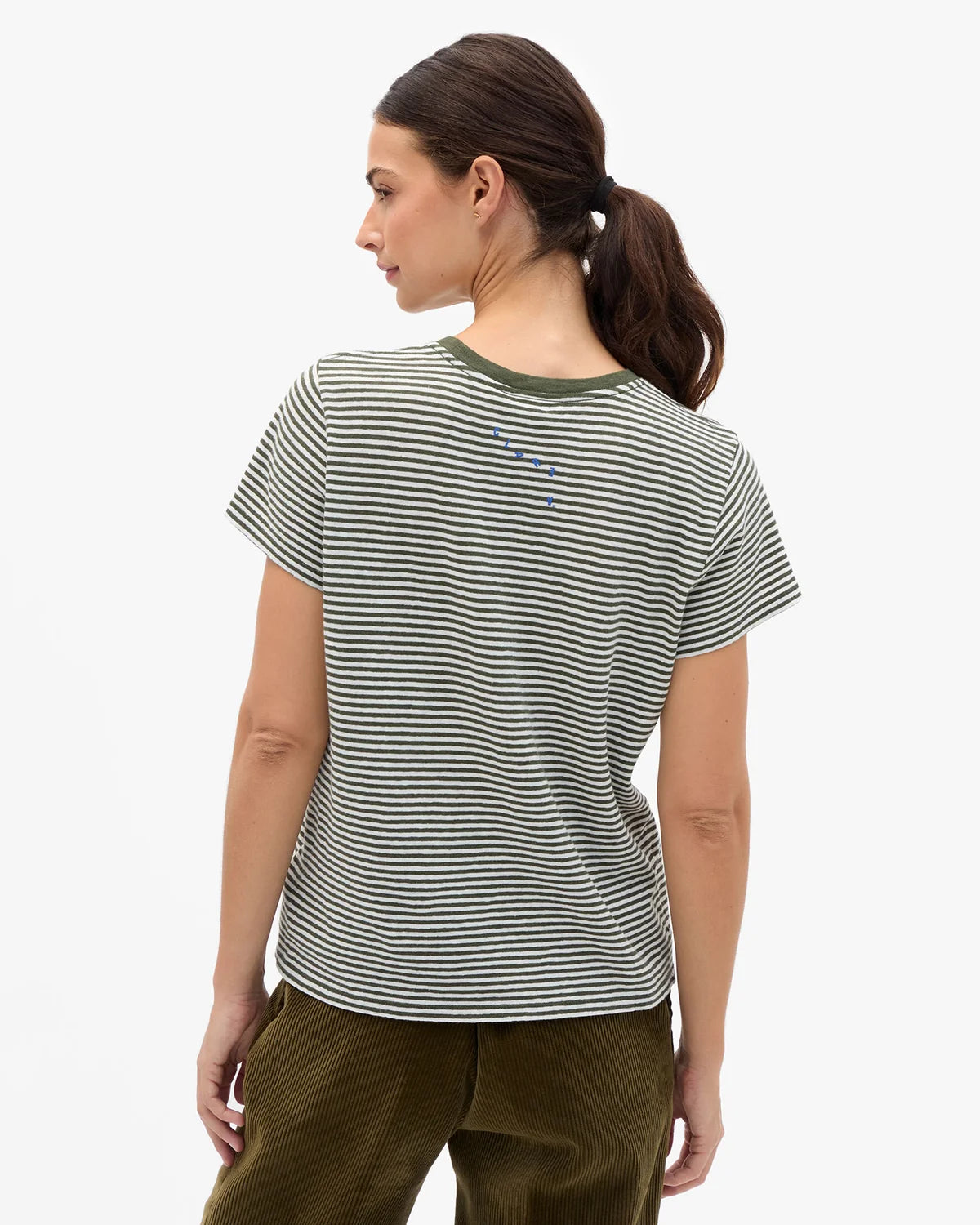 A woman shown from the back wearing a short-sleeve striped t-shirt with thin black and olive green horizontal stripes, paired with olive green pants, against a plain white background.