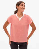 Woman wearing a red and white striped shirt on a white background