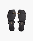 Pair of black sandals with gold accents on a white background