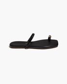 Black sandal with a strap on a white background