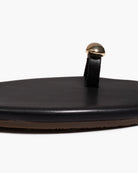 Black sandal with a gold toe ring on a white background