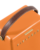 Close-up of an orange Fieldbar product with a brown handle on a white background