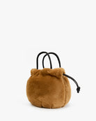 A small brown faux-fur drawstring pouch bag with black handles, photographed on a clean white background.
