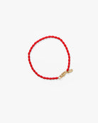 Red beaded bracelet with a gold clasp on a white background