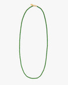 Green beaded necklace on a white background
