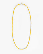 Yellow beaded necklace on a white background