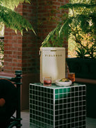 Outdoor setting with a 'Fieldbar' refrigerator, drinks, and snacks on a small table.