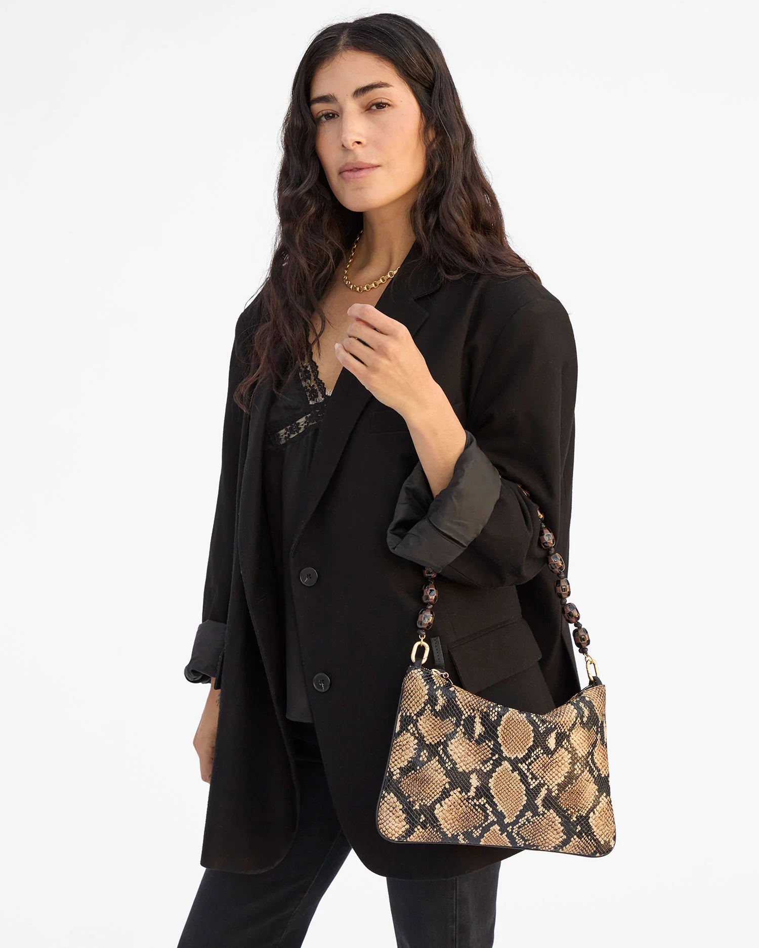 Woman holding a patterned handbag against a white background