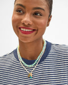 Woman wearing a necklace with a white background
