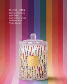 Candle with colorful design on a striped background