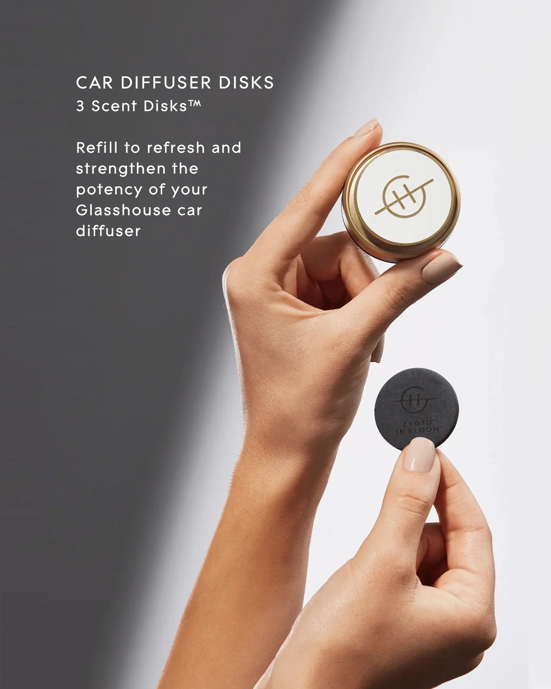 Hand holding a car diffuser disk with text about refreshing and strengthening the potency of a Glasshouse car diffuser.