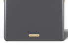 Dark gray electronic device with a gold label on a white background