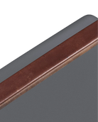 Close-up of a brown leather strip on a gray background