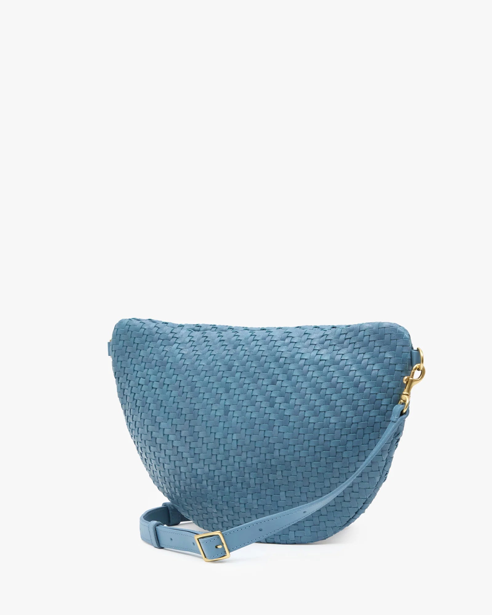 A blue woven crescent-shaped crossbody bag with a matching strap and gold-tone hardware, shown on a plain white background.