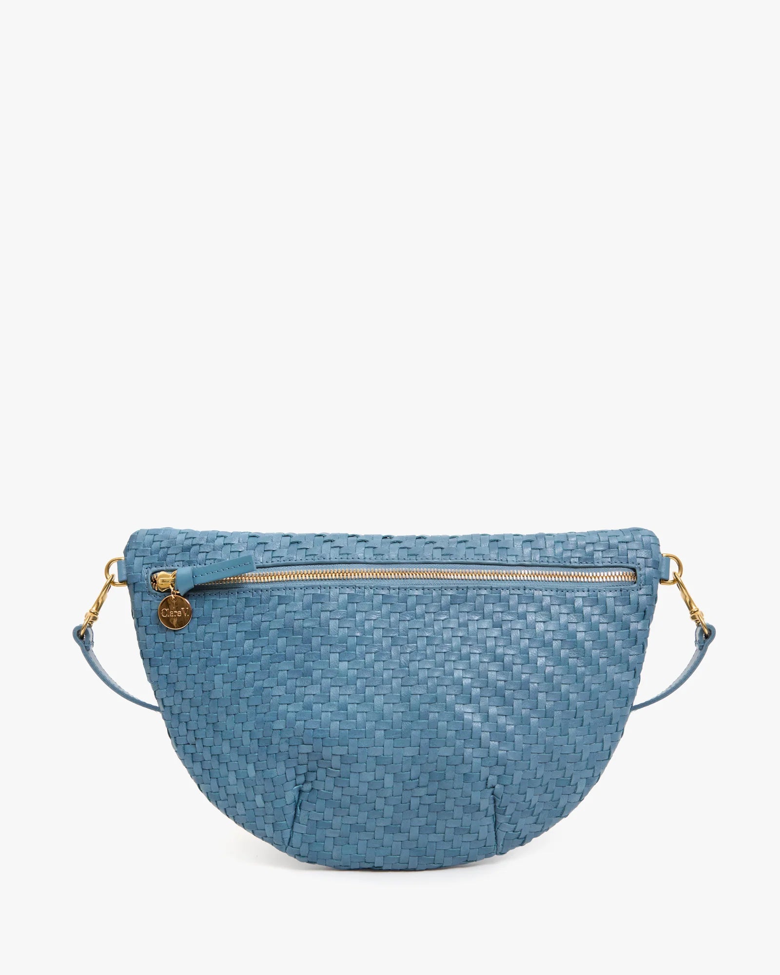 A blue woven leather half-moon crossbody bag with a top zipper, gold-tone hardware, and a matching blue strap, shown against a plain white background.