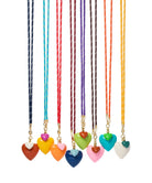 Set of colorful heart-shaped pendant necklaces on a white background