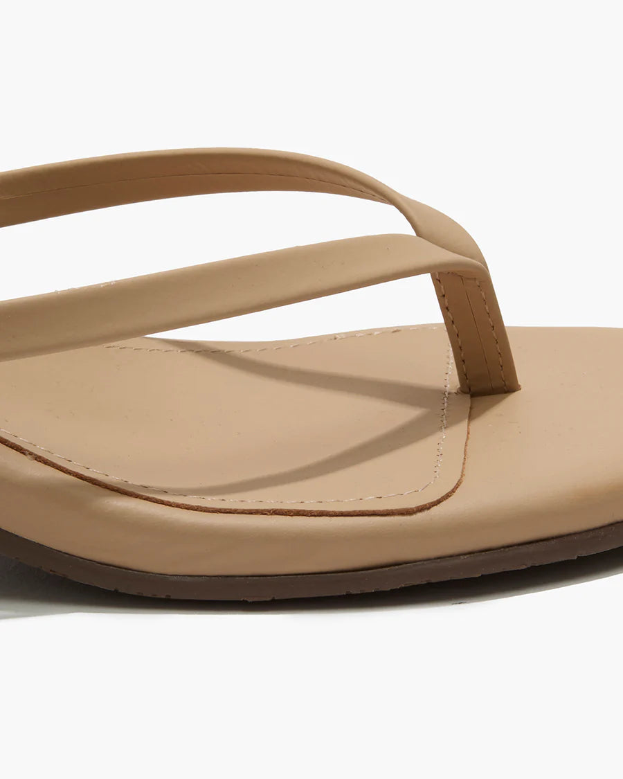 Beige sandal with a strap on a white background