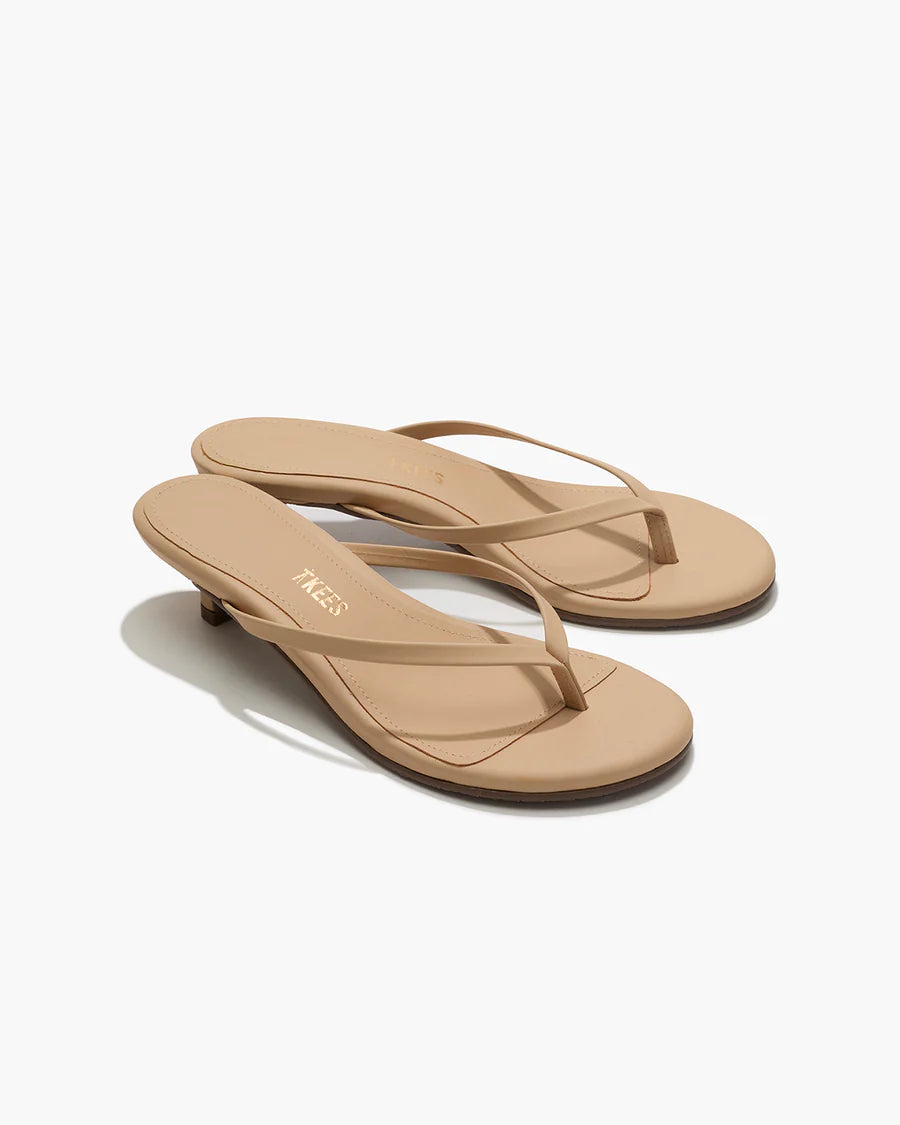 Pair of beige sandals on a white background