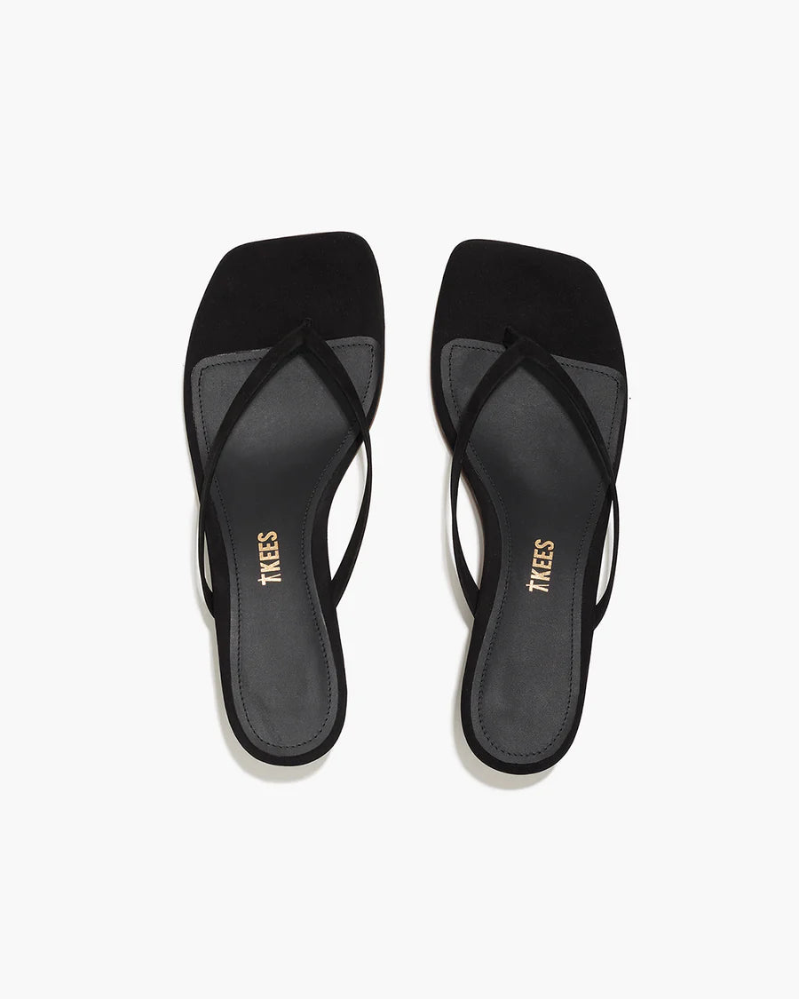 Black sandals with 'TKEES' branding on a white background