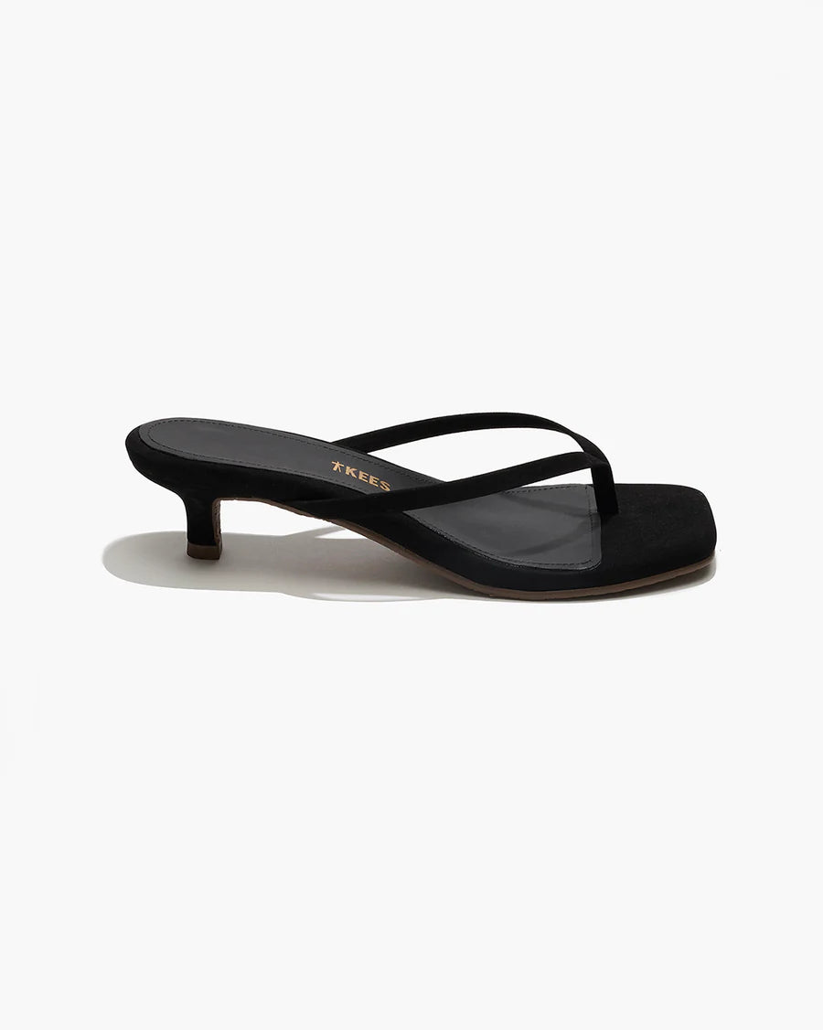 Black sandal with thin strap on a white background