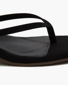 Black sandal with a strap on a white background