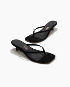Black sandals with a brand logo on a white background