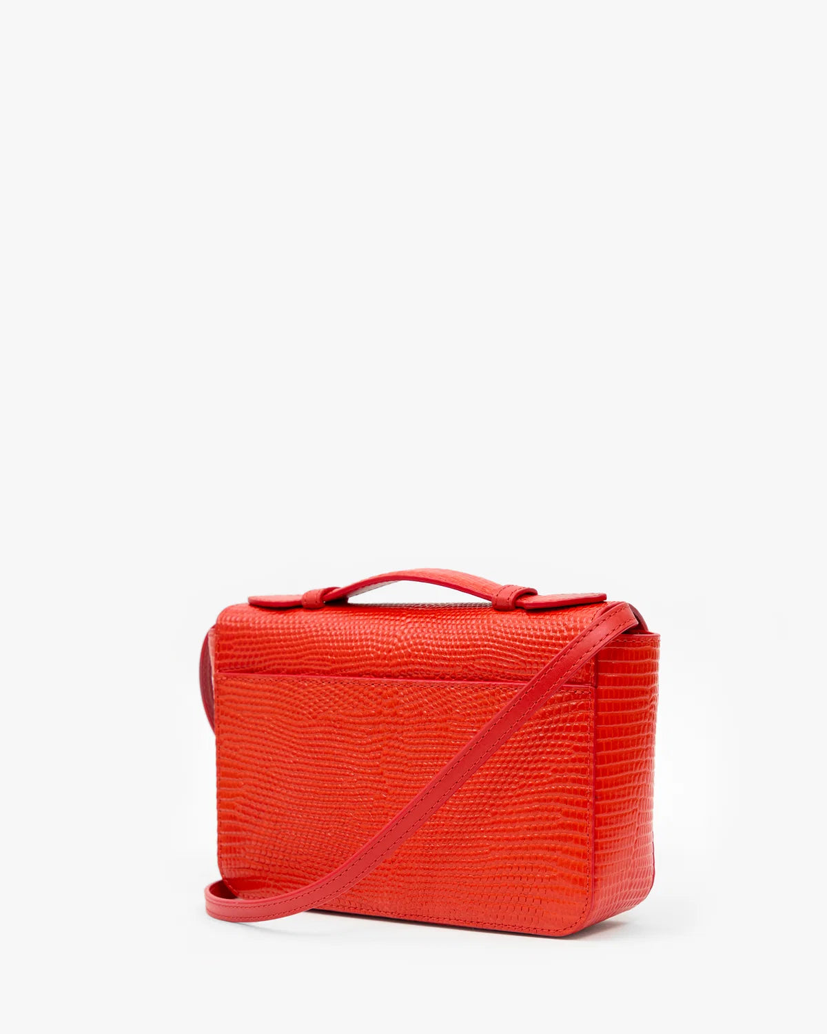 A bright red textured leather cosmetic bag with a top handle and a matching shoulder strap, shown on a clean white background.