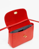 A bright red crocodile-embossed leather handbag with a top handle, a shoulder strap, and a gold-tone turn-lock closure on the front flap, shown against a plain white background.