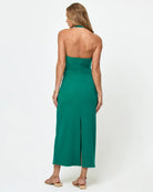 Woman wearing a green strapless dress on a white background