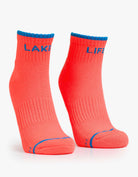 Pair of pink socks with blue accents on a white background