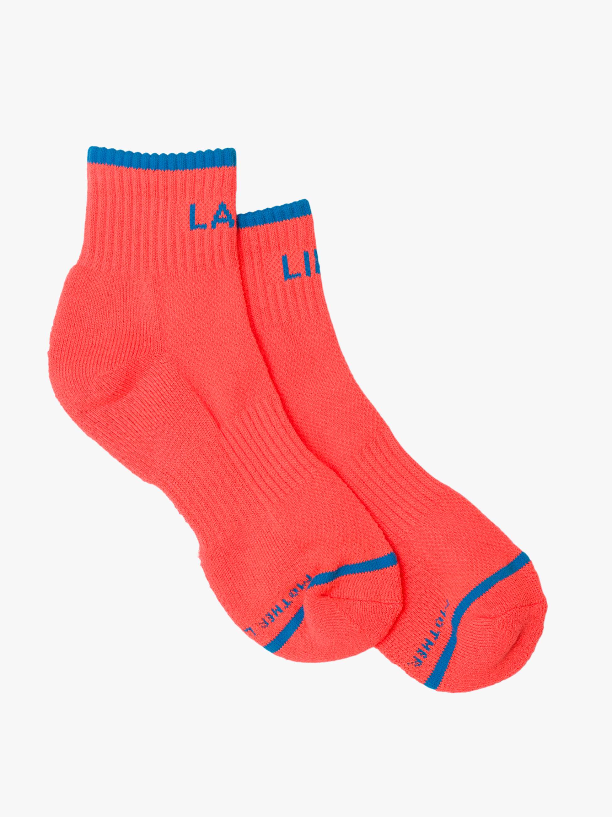 Pair of red socks with blue accents on a light gray background