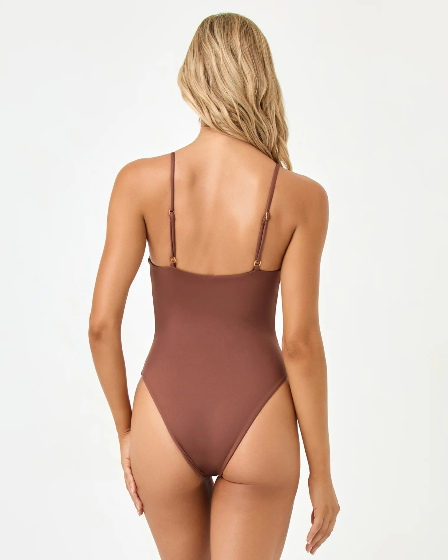 Brown swimsuit worn by a model on a white background