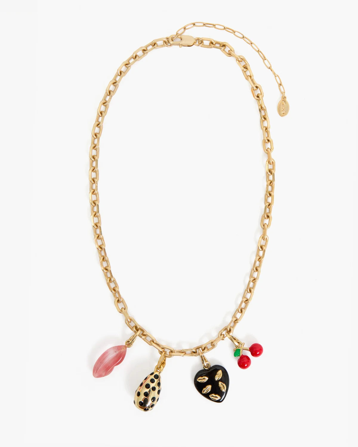 A gold-tone chain necklace with five dangling charms: a pink oval charm, a black-and-gold spotted teardrop charm, a black heart charm with gold details, and two small red-and-green berry charms, shown on a plain white background.