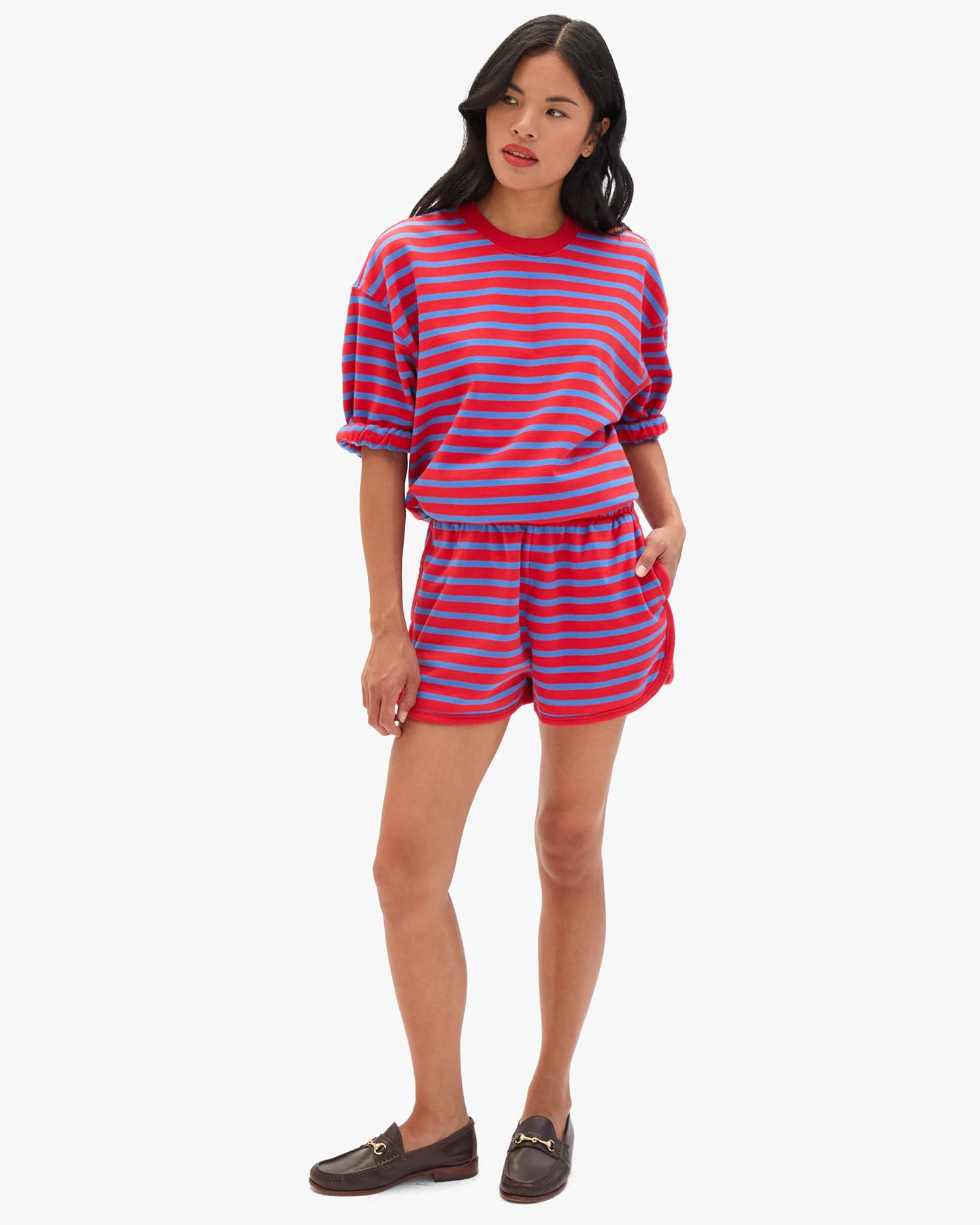Woman wearing a red and blue striped outfit on a white background