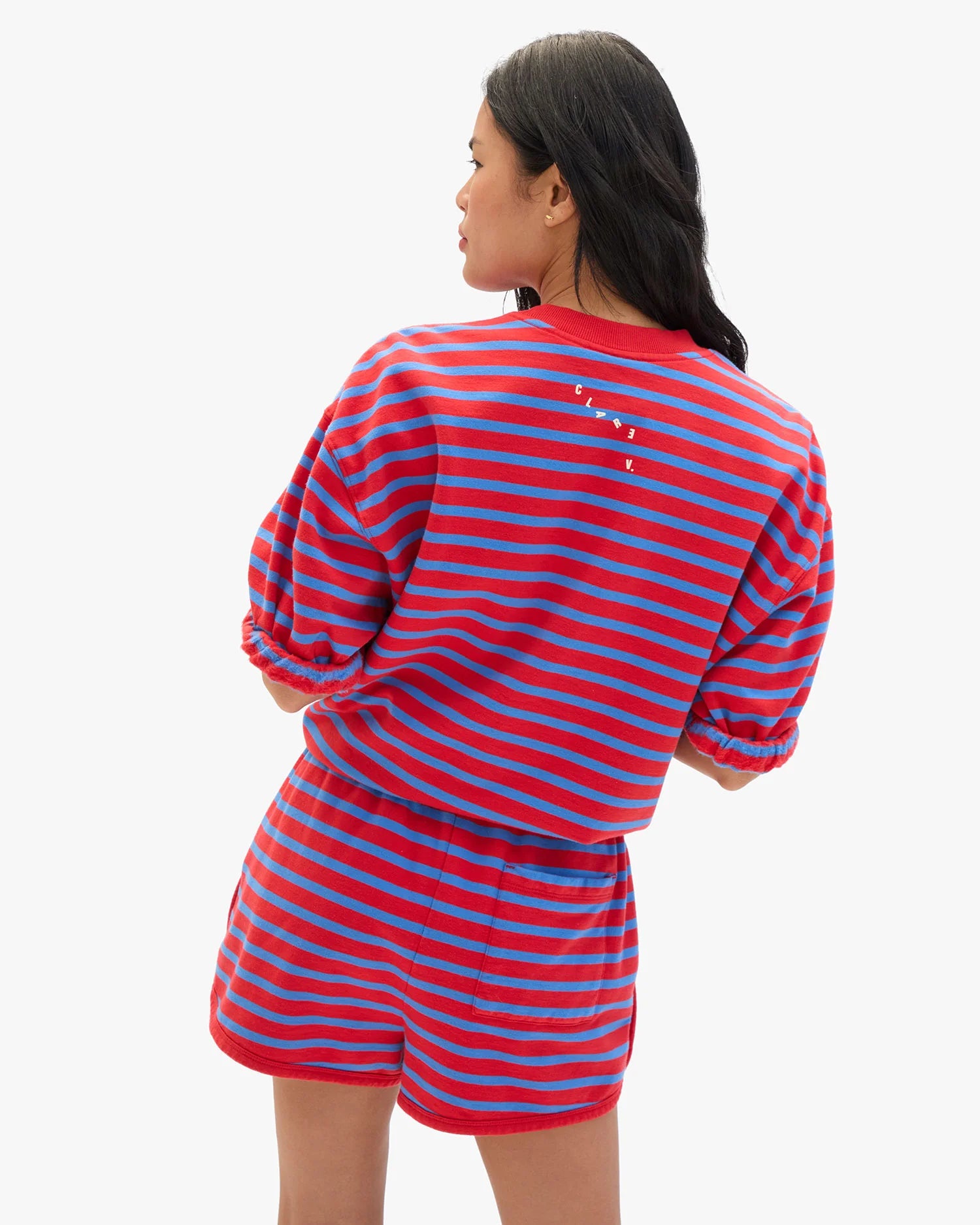Person wearing a red and blue striped outfit on a white background