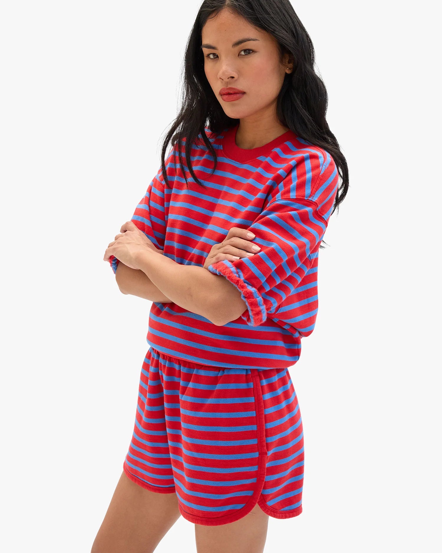 Woman wearing a red and blue striped outfit on a white background