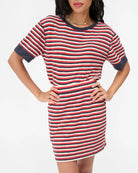 Woman wearing a red, white, and blue striped dress on a white background