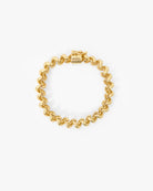 A gold chain bracelet with a distinctive wavy, zigzag link pattern and a matching clasp, displayed on a clean white background.