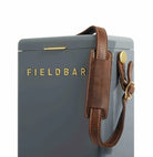 Gray box with 'FIELDBAR' branding and a brown leather strap on a white background