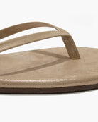 Beige sandal with a thong design on a white background