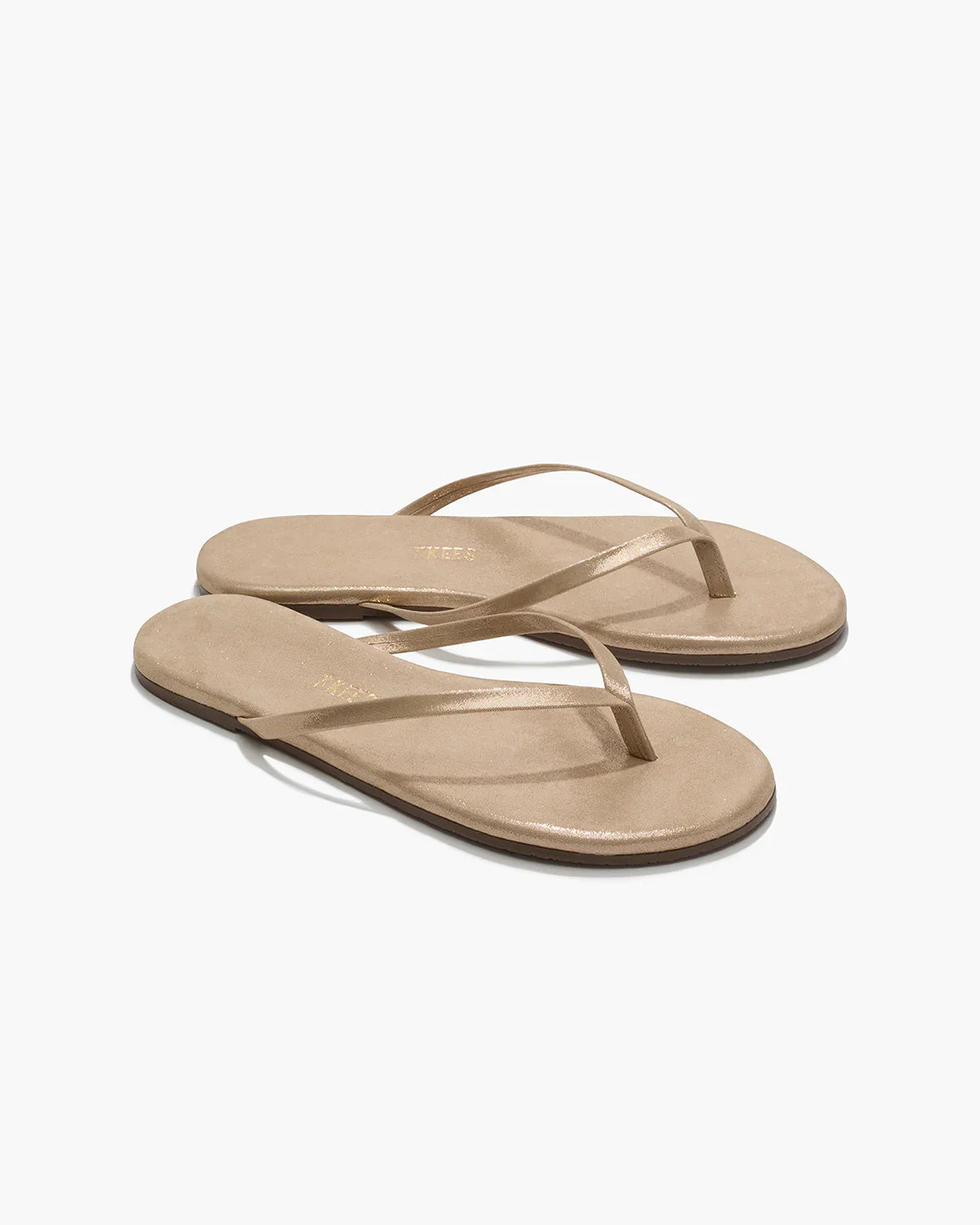 Pair of beige sandals on a white background